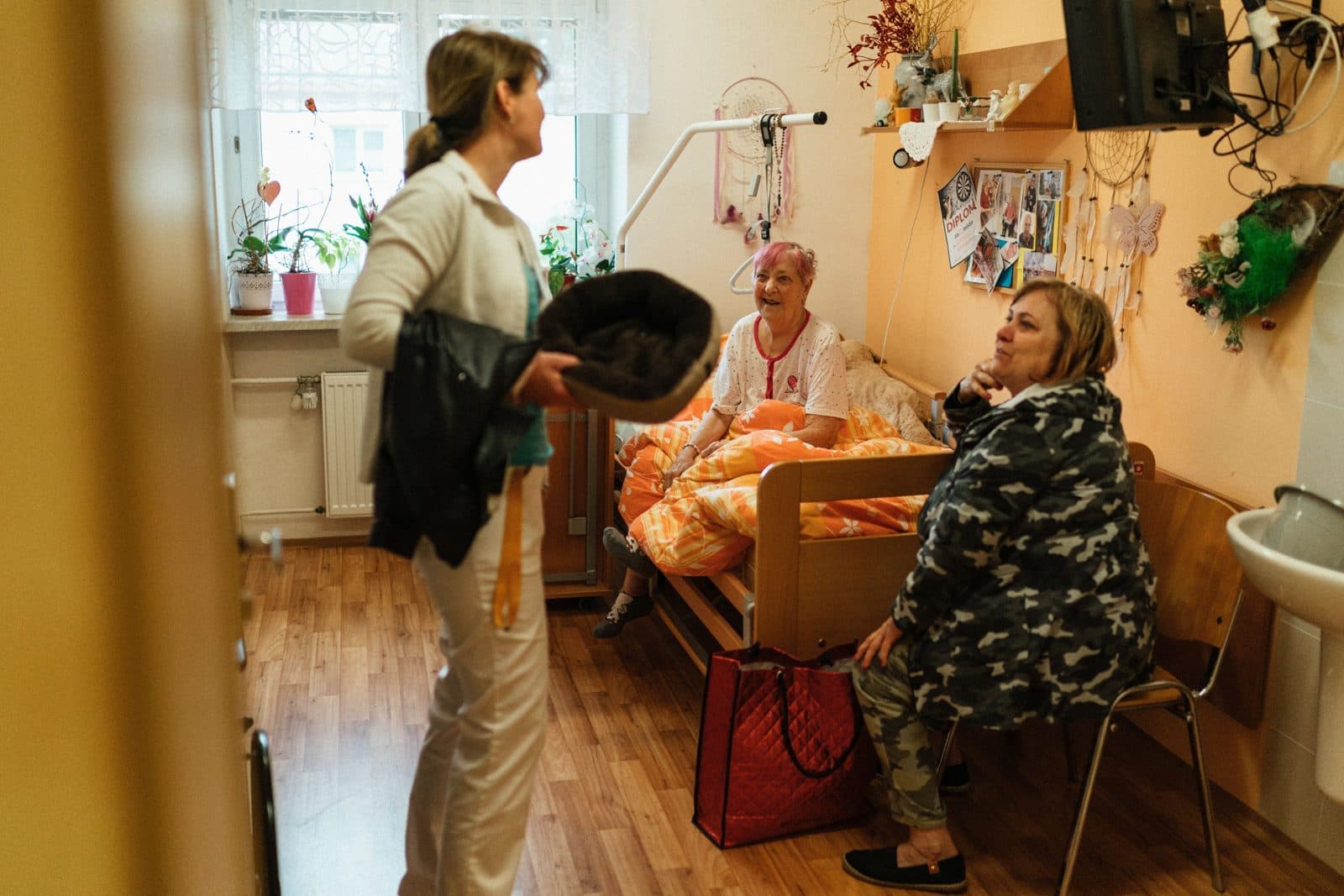 A care worker supporting an elderly resident in a care home